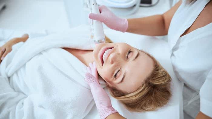 Woman having Secret Rf Microneedling treatment for neck area at Light Touch Laser Spa NYC